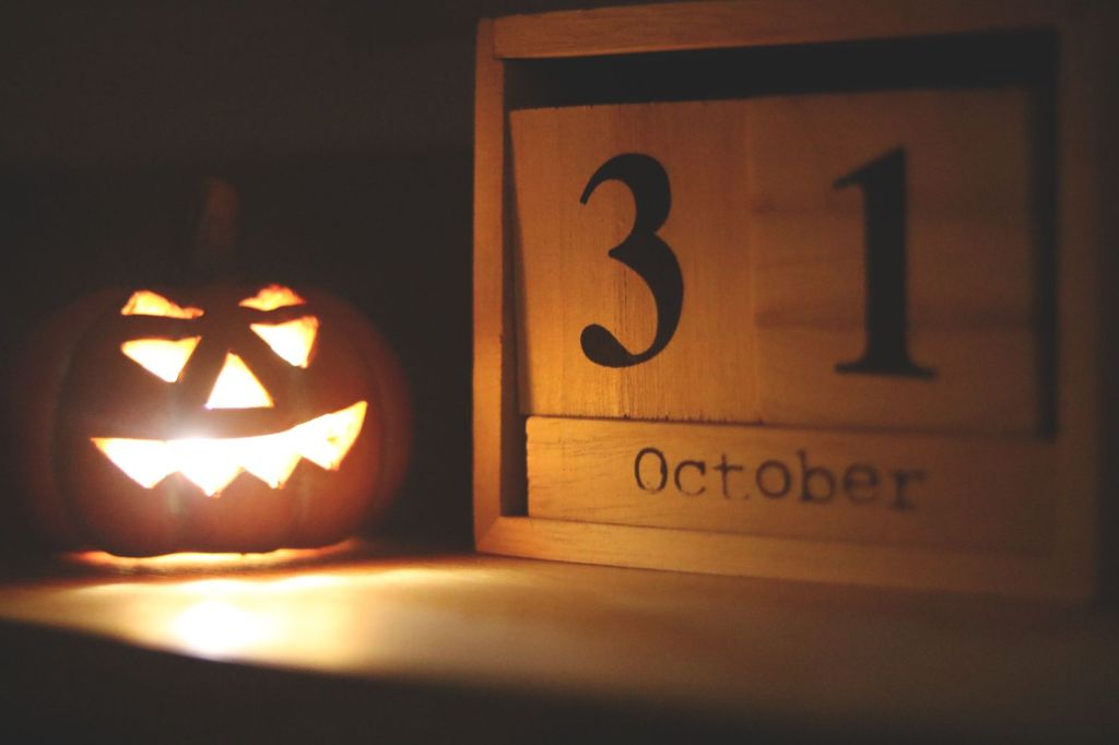 Glowing jack-o'-lantern beside an October 31 calendar — featured image for a Tissue & Me post about Halloween allergy horrors.